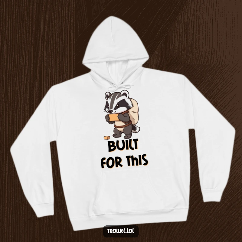 Funny badger hoodie depicting a strong character carrying a hefty bag of bricks, offering warmth and a humorous message of strength.